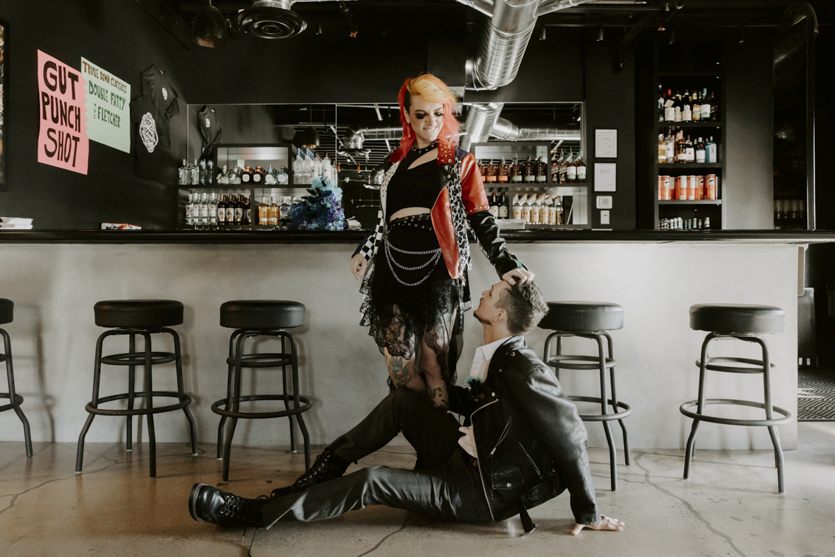 Rock star couple at a bar with a row of chairs.
